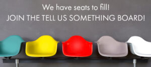 The image contains a text that says "We have seats to fill! JOIN THE TELL US SOMETHING BOARD!". The image displays 5 colorful chairs against a gray wall.